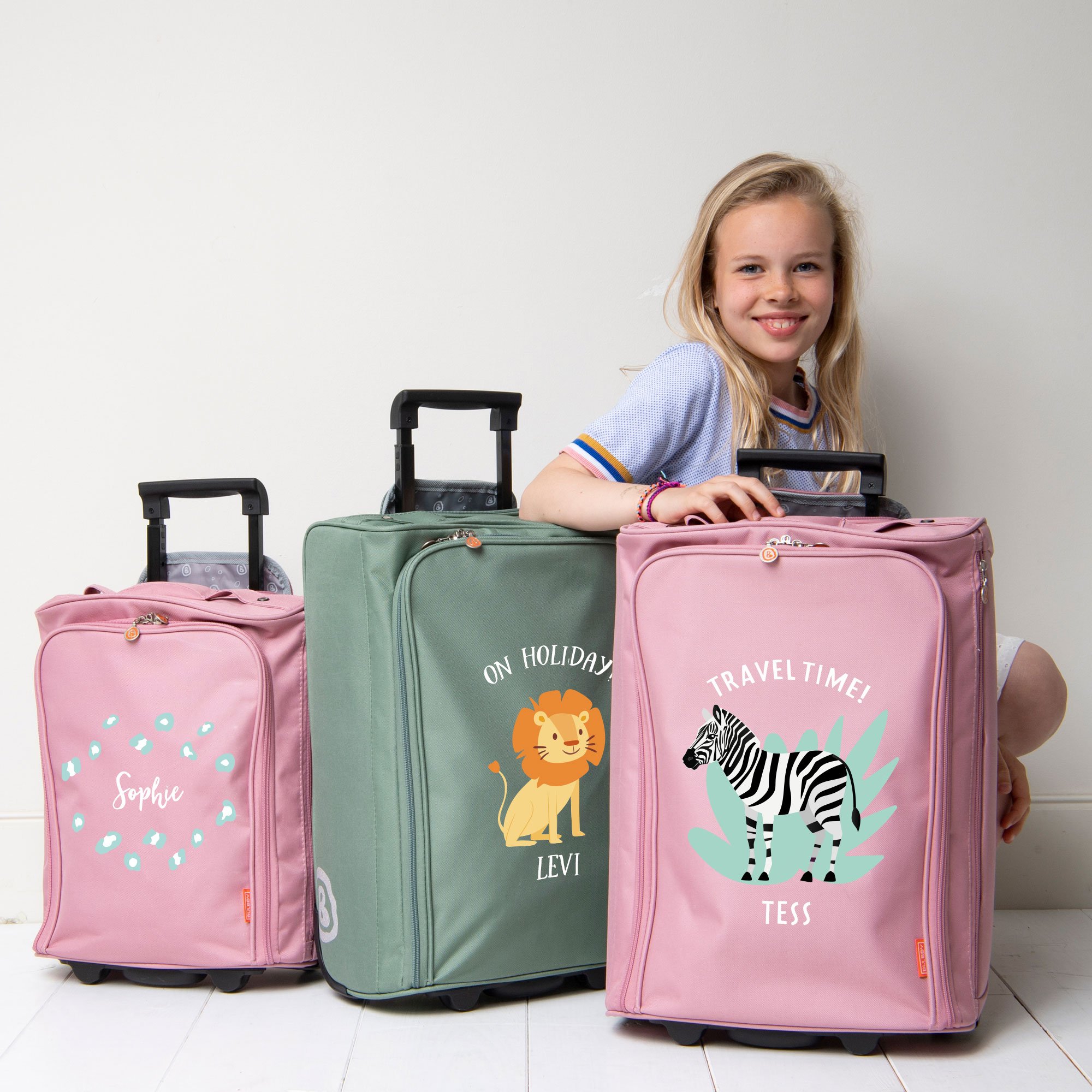 Girl with cute travel trolleys printed with own name